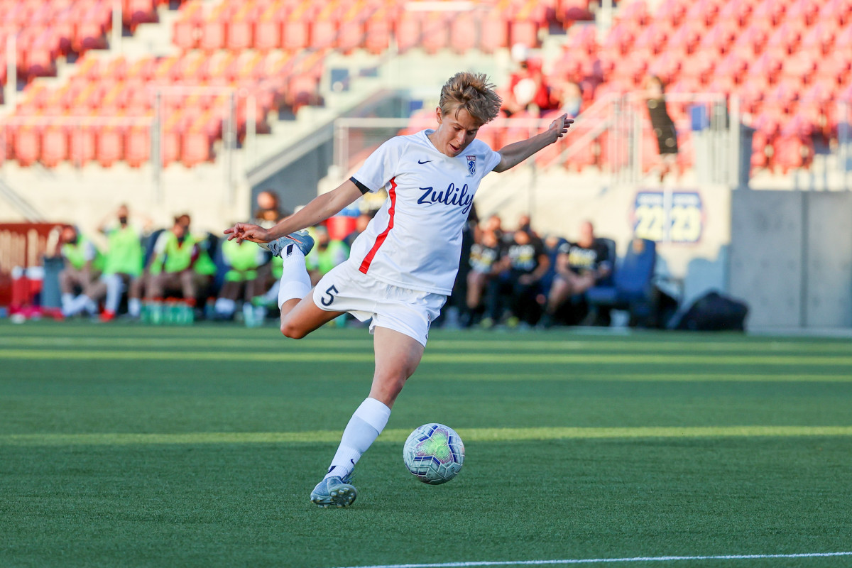 Quinn kicks a soccer ball